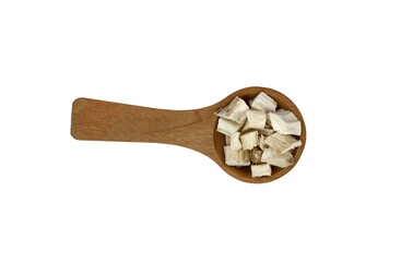 Wall Mural - Pile of dried and sliced marshmallow root (Althaea officinalis) in a wooden spoon isolated on white background