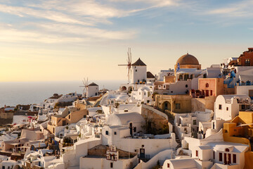 Sunset sky above traditional Greek village Oia on Santorini island in Greece. Santorini iconic view.