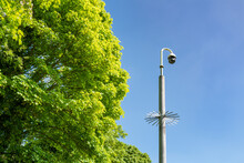 Isolated View Of A Newly Installed Exterior PTZ CCTV Security Camera Located In A Public Park. The Spiked Collar Is Used To Stop Climbing To The Camera.