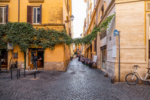 Narrow Street With Cafe And Small Shops In Rome. Italy Travel Concept, Visiting Cozy Places