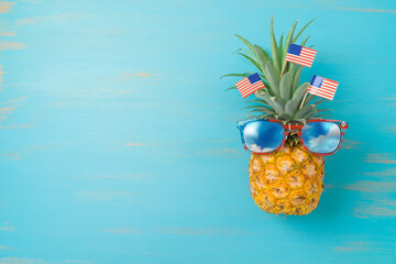 4th of July  creative concept with pineapple and American flag. Happy Independence Day background. Top view, flat lay