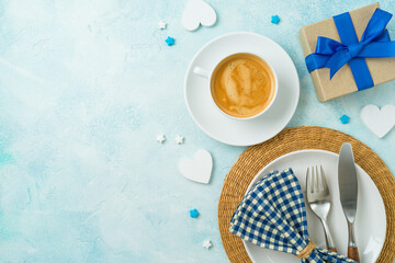 Coffee cup, gift box and plate on table for Father's day festive breakfast. Flat lay background, top view