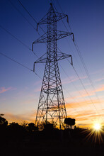 Silhouette Of An Electric Tower At Sunset . Energy Concept