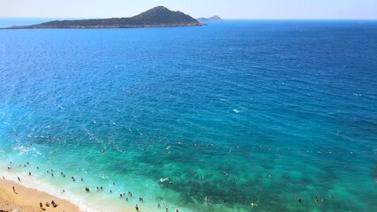 Wall Mural - Drone footage of people sunbathing on Kaputaş beach near Kalkan - Kaş, Antalya, Turkey