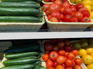 Vegetables and fruits are sold in the store on the shelves. Tomatoes, citrus fruits are laid out in baskets in the store on the counter. Mockup for price tags.