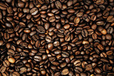 Fototapeta Dinusie - Close-up of roasted brown coffee beans background
