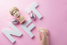 NFT Non-Fungible Token And Artificial Arm On A Pink Background. Crypto Art Concept With Antique Bust And Robotic Arm. Technology Selling Unique Collectibles And Blockchain Assets