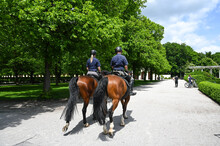 Police Patrol On The Horses In City Park. Policeman. 
