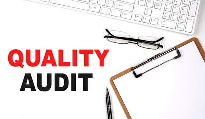Poster - QUALITY AUDIT text written on white background with keyboard, paper sheet and pen