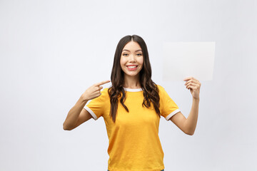 Wall Mural - surprised young girl in yellow shirt with white placard in hands isolated