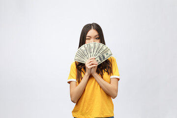 Wall Mural - Closeup portrait of beautiful asian woman holding money isolated on white background. Asian girl counting her salary dollar note. Success wealth financial business cashflow currency payment concept