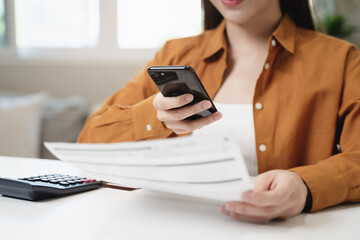 hands of woman using mobile smart phone for scan and payment bill online