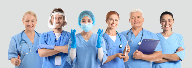 Wall Mural - Many different doctors on grey background