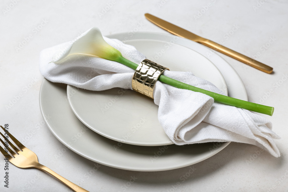 Beautiful table setting with calla lily on light background, closeup