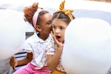 Wall Mural - Cute little girls with cotton candy outdoors