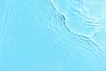 Texture of water with ripples on blue background, closeup