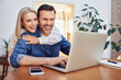 © baranq - Happy mid adult couple at home using laptop surfing the net