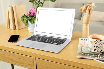 Sticker - Workplace with modern laptop, mobile phone, cup and magazines in room