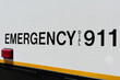 Emergency dial 911 sign on the side of the police car. Close up.