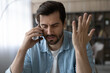 © fizkes - Professional misfortune. Troubled casual businessman call boss partner discuss business failure ask for advice in difficult situation. Unhappy young male share personal problems with friend by phone