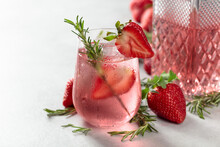 Refreshing Drink With Natural Ice, Strawberries, And Rosemary.