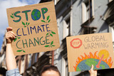 Fototapeta Mapy - Protesters holding signs Stop Climate Change and Stop Global warming. People with placards at protest rally demonstration strike.