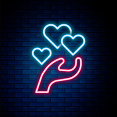 Wall Mural - Glowing neon line Heart in hand icon isolated on brick wall background. Hand giving love symbol. Valentines day symbol. Colorful outline concept. Vector