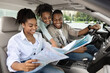 © Prostock-studio - Happy African Parents And Daughter Sitting In Car Holding Map
