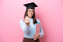 Young Student Brazilian Woman Wearing Graduated Hat Isolated On Pink Background Inviting To Come With Hand. Happy That You Came