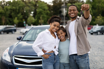 Wall Mural - Happy Black Family Showing New Car Key Standing Outdoor