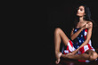 © totojang1977 - Beautiful and sexy Asian lady in white bra lingerie and The United States of America flag in balcony room with dark wall background