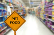 © janews094 - Blur image of pet food aisle in supermarket with message