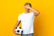 English football player over isolated yellow background covering eyes by hands. Do not want to see something