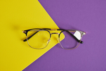 Sticker - trendy eye glasses on a purple and yellow background glasses for study, computer work and reading