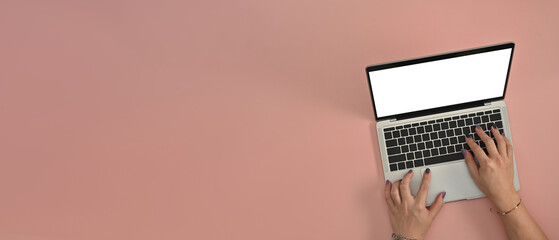 Poster - Male colored nail hands typing keyboard with a blank white screen computer laptop ready for your text or advertisement on the light pink background. Flat lay composition.