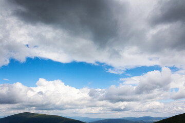 Wall Mural - grey clouds on a blue sky. calm nature background. weather change before the rain