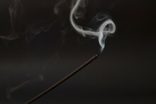 Incense Stick With Smoke On A Black Background