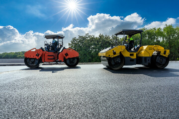 Wall Mural - Construction site is laying new asphalt pavement. road construction workers and road construction machinery scene. Highway construction site scene in China.