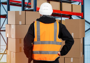 Poster - Storekeeper his back to camera. Man in orange vest and hardhat. Storekeeper counts boxes. Shelves with parcels in background. Career storekeeper in distribution center. Logistics warehouse worker