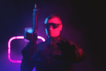 A bodyguard man in the neon lights. Cyberpunk concept.