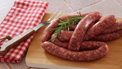 Wall Mural - raw sausages for grilling on a wooden board