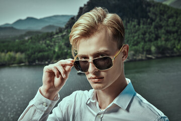 Wall Mural - blond man by the lake