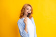 © Olena - Summer concept. Glad positive woman holds tasty frozen ice cream, enjoys eating delicious cold dessert, poses on yellow background, feels happy. Female model enjoy ice-cream.
