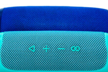 Two New Wireless Speakers On A White Background, One Turquoise And The Other Blue.