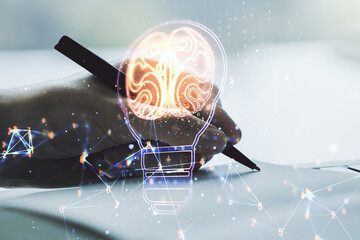 Poster - Double exposure of creative light bulb hologram with human brain and with man hand writing in notebook on background, idea and brainstorming concept