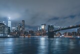 Fototapeta  - Brooklyn Bridge at Night with Water Reflection in New York City