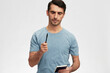 © SHOTPRIME STUDIO - man with a notepad in hand casual wear posing emotions isolated background