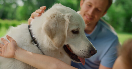 Wall Mural - Happy dog enjoy caressing on picnic close up. Smiling man fondle white pet.