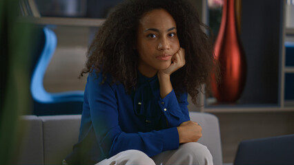 Focused african american business woman looking camera sitting in workplace.