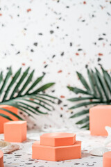 Poster - peach geometric pedestal on terrazzo background with summer sunlight and green palm leaf